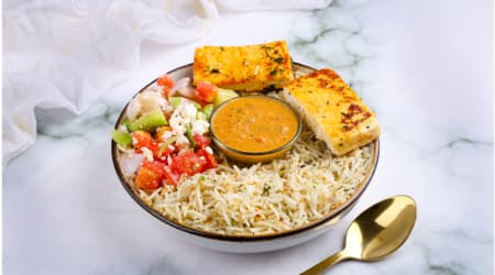 Grilled paneer with herb rice, salad and a bowl of curry